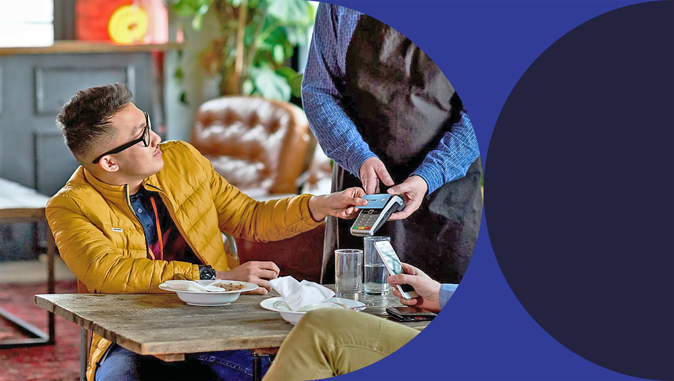 person paying tableside with card