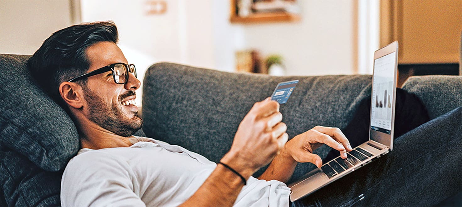 man typing in card number online