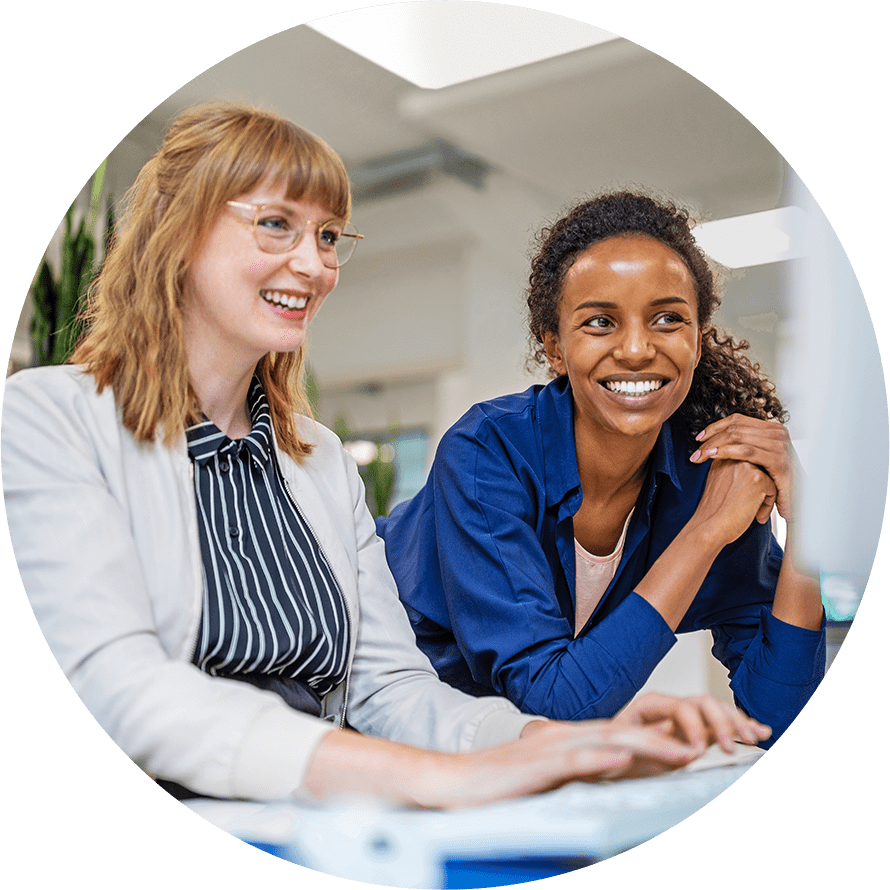 two coworkers smiling while working
