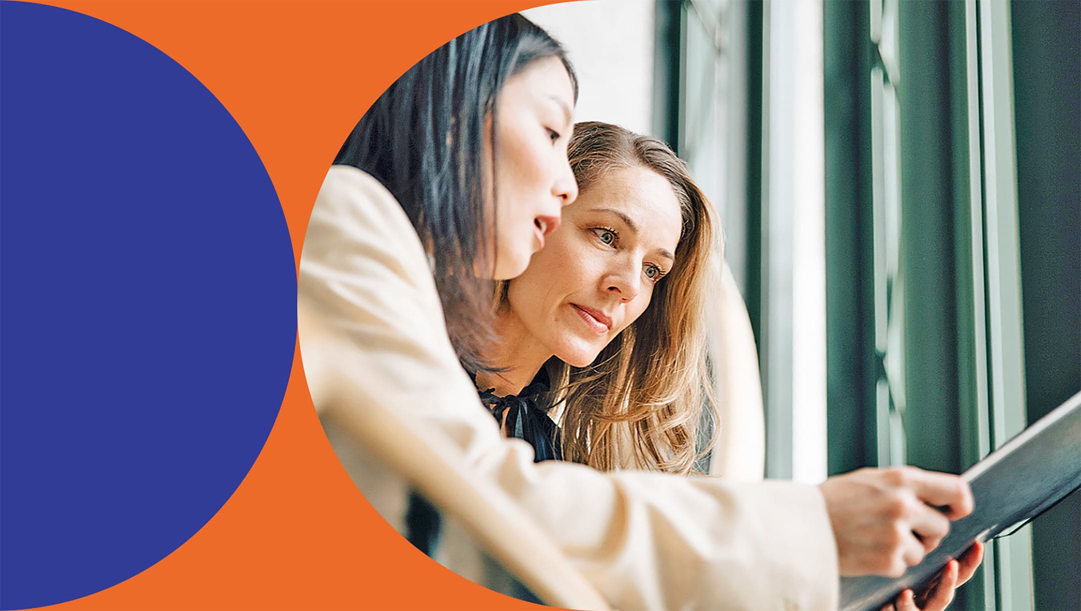 two people looking at a tablet together